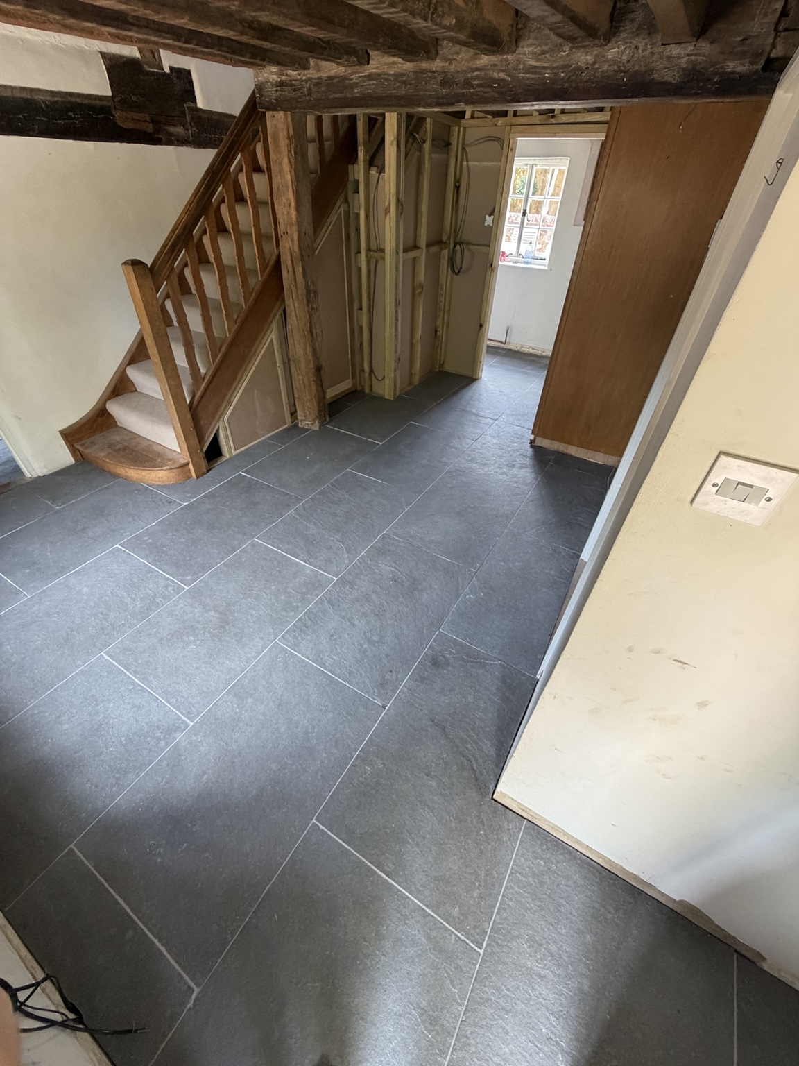 Large limestone tiled floor through a hallway